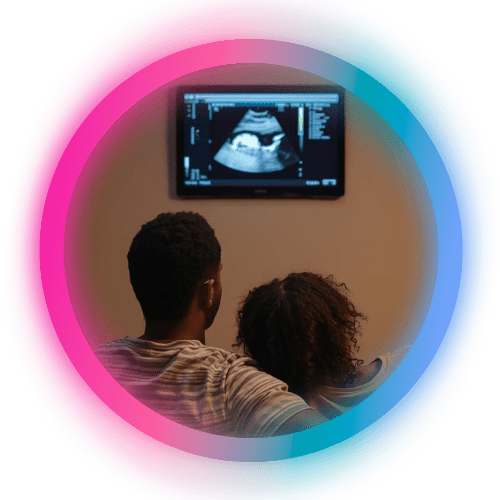 Couple looking at an ultrasound scan on a TV screen